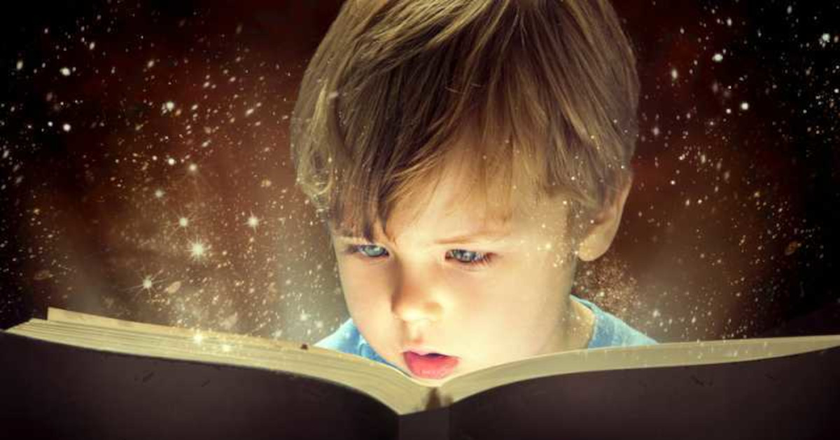 A boy faces an open book as the pages glow and encompass him with a magical aura.